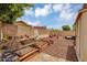 Serene backyard featuring raised garden beds, a cozy fire pit, and a peaceful outdoor setting at 10226 W Country Club Trl, Peoria, AZ 85383
