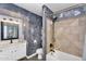 Stylish bathroom with decorative wall and tub/shower combo at 10226 W Country Club Trl, Peoria, AZ 85383