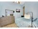 Bright bedroom featuring a neutral color palette, dresser with mirror and modern lamp at 10226 W Country Club Trl, Peoria, AZ 85383