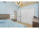 Bedroom with light blue walls, ceiling fan, and closet with sliding doors at 10226 W Country Club Trl, Peoria, AZ 85383