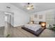 Bright bedroom with a platform bed, wood-look floors and ceiling fan at 10226 W Country Club Trl, Peoria, AZ 85383