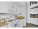 Bright kitchen featuring white appliances, granite countertops, and modern cabinetry at 10226 W Country Club Trl, Peoria, AZ 85383