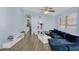 Bright and airy living room with light blue walls, modern furniture, and access to kitchen through arch at 10226 W Country Club Trl, Peoria, AZ 85383