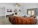 Comfortable living room with stone fireplace, large sofa and updated ceiling fan at 10226 W Country Club Trl, Peoria, AZ 85383
