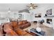 Bright and spacious living room with a fireplace and open concept to the kitchen and dining room at 10226 W Country Club Trl, Peoria, AZ 85383