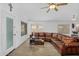 Bright living room featuring a leather sectional and access to multiple windows at 10226 W Country Club Trl, Peoria, AZ 85383