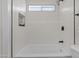 Cozy bathroom featuring a tub, updated shower head, and updated tile work at 10612 N 48Th Ave, Glendale, AZ 85304