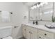 Updated bathroom with white vanity, framed mirror, updated fixtures, and shower at 10612 N 48Th Ave, Glendale, AZ 85304