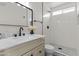 Modern bathroom featuring tile backsplash, vanity with framed mirror, and a shower with a glass enclosure at 10612 N 48Th Ave, Glendale, AZ 85304