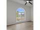 Well-lit bedroom featuring a large window, ceiling fan, and light wood flooring at 10612 N 48Th Ave, Glendale, AZ 85304