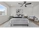 Brightly lit bedroom featuring a large window, ceiling fan, and contemporary furnishings and decor at 10612 N 48Th Ave, Glendale, AZ 85304