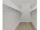 Walk-in closet with built-in shelving and wood look flooring, great for organization and storage at 10612 N 48Th Ave, Glendale, AZ 85304
