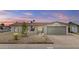 Charming single-story home featuring a well-maintained front yard with desert landscaping and a two-car garage at 10612 N 48Th Ave, Glendale, AZ 85304