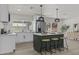 Bright kitchen with modern island, pendant lighting, stainless steel appliances, and views of the backyard at 10612 N 48Th Ave, Glendale, AZ 85304