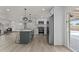 Updated kitchen features a kitchen island with barstool seating and stainless steel appliances at 10612 N 48Th Ave, Glendale, AZ 85304