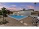 Backyard view showcasing the pool at dusk, along with the rear exterior of the home at 10612 N 48Th Ave, Glendale, AZ 85304