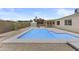 Wide view of the refreshing pool and landscaped backyard with covered patio at 10612 N 48Th Ave, Glendale, AZ 85304