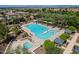 Aerial shot featuring a large swimming pool and jacuzzi with palm trees and shady gazebos at 1086 S Nancy Ln, Gilbert, AZ 85296