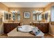 Bathroom features an oversized soaking tub, double sinks, tile floors, and decorative mirrors at 1086 S Nancy Ln, Gilbert, AZ 85296