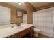 Bathroom features a tiled floor, stylish vanity, a mirror, and a shower with a curtain at 1086 S Nancy Ln, Gilbert, AZ 85296