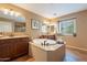 Bathroom features an oversized soaking tub, double sinks, tile floors, and a large window at 1086 S Nancy Ln, Gilbert, AZ 85296