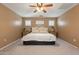Comfortable bedroom boasts a ceiling fan, large bed, and windows with stylish shutters, with carpet floor at 1086 S Nancy Ln, Gilbert, AZ 85296