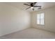 Well-lit bedroom features plush carpeting, ceiling fan and natural light from a shuttered window at 1086 S Nancy Ln, Gilbert, AZ 85296
