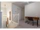Bright hallway features a desk with a chair, decorative art, and an attractive light fixture on the stairway at 1086 S Nancy Ln, Gilbert, AZ 85296