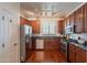 Well-equipped kitchen with stainless steel appliances, dark cabinets, and granite countertops at 1086 S Nancy Ln, Gilbert, AZ 85296
