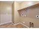 Functional laundry room with tile flooring, utility connections, and built-in shelving at 1086 S Nancy Ln, Gilbert, AZ 85296