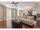 Bright living room with hardwood floors, neutral decor, and sliding glass doors to the outside at 1086 S Nancy Ln, Gilbert, AZ 85296
