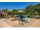 Community playground with green and blue play equipment, swings, and a shaded canopy at 1086 S Nancy Ln, Gilbert, AZ 85296