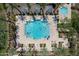 Aerial view of a sparkling blue community pool featuring lounge chairs, cabanas and lush palm trees in a well maintained community at 1086 S Nancy Ln, Gilbert, AZ 85296
