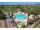 Aerial view of a sparkling blue community pool with plentiful lounge seating and shaded cabanas in a lush, landscaped setting at 1086 S Nancy Ln, Gilbert, AZ 85296
