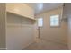 Bright walk-in closet with natural light, built in shelving, and carpeted floor at 1086 S Nancy Ln, Gilbert, AZ 85296
