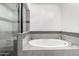 Luxurious bathroom boasting a soaking tub, elegant tile accents, and a glass-enclosed shower at 1111 W University Dr # 3016, Tempe, AZ 85281