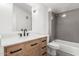 Stylish bathroom featuring a wood vanity, modern fixtures, and a shower-tub combo for comfort at 1111 W University Dr # 3016, Tempe, AZ 85281