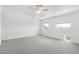 Neutral bedroom featuring soft carpet, ceiling fan, and sunny windows with neighborhood views at 1111 W University Dr # 3016, Tempe, AZ 85281