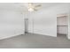 Spacious bedroom with neutral carpet, ceiling fan, and white walls leading to closet at 1111 W University Dr # 3016, Tempe, AZ 85281