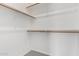 Bright, walk-in closet with built-in wooden rods and shelving for optimal storage at 1111 W University Dr # 3016, Tempe, AZ 85281