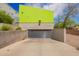 Modern garage with a gray door, concrete flooring and walls, and a bright green building on top at 1111 W University Dr # 3016, Tempe, AZ 85281