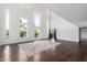 Bright living room with tall windows and hardwood floors, featuring a large decorative area rug at 1111 W University Dr # 3016, Tempe, AZ 85281