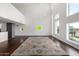 Bright living room with tall windows and hardwood floors, featuring a large decorative area rug at 1111 W University Dr # 3016, Tempe, AZ 85281