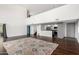 Bright living room with tall windows and hardwood floors, featuring a large decorative area rug and open kitchen at 1111 W University Dr # 3016, Tempe, AZ 85281