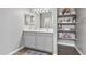 Stylish bathroom featuring a double vanity with modern fixtures and open shelving at 12105 W Wier Ave, Avondale, AZ 85323