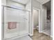 Bathroom showcasing glass-enclosed shower with tiled surround and adjacent toilet area at 12105 W Wier Ave, Avondale, AZ 85323