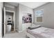 Bedroom with a built-in closet for storage, a white bed and a window letting in natural light at 12105 W Wier Ave, Avondale, AZ 85323