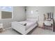 Bright bedroom features a white bed frame, neutral walls, and window with natural light at 12105 W Wier Ave, Avondale, AZ 85323