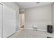 Simple bedroom with a closet, a nightstand, and neutral-colored walls and carpet at 12105 W Wier Ave, Avondale, AZ 85323