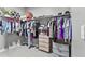 Walk-in closet featuring ample storage with hanging racks and shelving at 12105 W Wier Ave, Avondale, AZ 85323